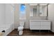 Clean bathroom featuring subway tiles, a modern double sink vanity, and a window providing natural light at 2305 Pine Ter, Sarasota, FL 34231