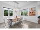 Modern dining room with a natural wood table, white chairs, and contemporary lighting at 2305 Pine Ter, Sarasota, FL 34231