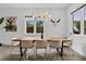Bright dining room featuring a wooden table, unique light fixture and ample natural light at 2305 Pine Ter, Sarasota, FL 34231
