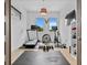 Bright and airy home gym with hardwood floors and equipped with modern fitness machines and equipment at 2305 Pine Ter, Sarasota, FL 34231