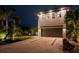 Beautiful two-story home featuring a modern exterior, a spacious driveway, and lush landscaping at 2305 Pine Ter, Sarasota, FL 34231