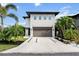 Beautiful two-story home featuring a modern exterior, a spacious driveway, and lush landscaping at 2305 Pine Ter, Sarasota, FL 34231
