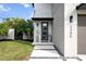 Inviting front entrance with modern door, sleek landscaping, and stylish pathway at 2305 Pine Ter, Sarasota, FL 34231