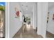 Bright, modern hallway with polished floors, contemporary art, and open sightlines to the outdoors at 2305 Pine Ter, Sarasota, FL 34231