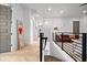 Bright upstairs hallway with hardwood floors, modern railing, and stylish decor at 2305 Pine Ter, Sarasota, FL 34231