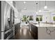 Bright, open kitchen with stainless steel refrigerator and dark wood lower cabinets at 2305 Pine Ter, Sarasota, FL 34231