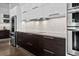 Elegant kitchen with stainless steel appliances, sleek countertops, and modern cabinetry at 2305 Pine Ter, Sarasota, FL 34231