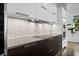 Close-up of modern kitchen featuring sleek countertops, stylish backsplash, and modern appliances at 2305 Pine Ter, Sarasota, FL 34231