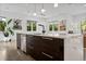 Modern kitchen island with quartz countertop, dark wood cabinets, and stainless steel appliances at 2305 Pine Ter, Sarasota, FL 34231