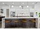 Modern kitchen with island, barstool seating, and sleek white cabinetry at 2305 Pine Ter, Sarasota, FL 34231