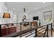 Upstairs living area featuring a work space with chic decor, modern furniture, and natural light at 2305 Pine Ter, Sarasota, FL 34231