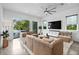 Bright living room featuring a large TV, plush seating, and sliding doors to the pool area at 2305 Pine Ter, Sarasota, FL 34231