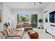 Comfortable living room featuring a large sectional sofa, area rug, and view to backyard at 2305 Pine Ter, Sarasota, FL 34231