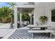 Stylish outdoor living space features cozy seating, modern decor, and a concrete table with bench seating at 2305 Pine Ter, Sarasota, FL 34231