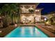 Stunning backyard with pool, lounge area, outdoor dining, and elegant lighting for evening entertaining at 2305 Pine Ter, Sarasota, FL 34231