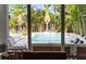 View of the backyard pool and tropical landscaping from the living room at 2305 Pine Ter, Sarasota, FL 34231