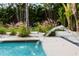 Inviting pool area featuring a modern water fountain feature and lush tropical landscaping at 2305 Pine Ter, Sarasota, FL 34231