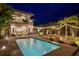 Backyard oasis with a sparkling pool, inviting lounge areas, and ambient string lights for evening enjoyment at 2305 Pine Ter, Sarasota, FL 34231