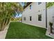 Side yard enhanced with artificial turf, providing a lush and low-maintenance outdoor space at 2305 Pine Ter, Sarasota, FL 34231