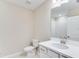 Bathroom features a toilet and a white vanity with a white sink at 23445 Collina Way # 10103, Port Charlotte, FL 33980