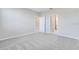 Spacious bedroom features neutral carpeting and paint with multiple doorways at 23445 Collina Way # 10103, Port Charlotte, FL 33980