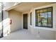 Inviting entrance with a dark front door, natural light from a large window and a fire extinguisher at 23445 Collina Way # 10103, Port Charlotte, FL 33980