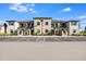 Beautiful exterior view of a multi-Gathering residence with lush landscaping and a spacious parking area at 23445 Collina Way # 10103, Port Charlotte, FL 33980