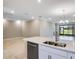 Open kitchen and living area with stainless steel appliances and tile flooring at 23445 Collina Way # 10103, Port Charlotte, FL 33980