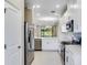 Well-lit kitchen with stainless steel appliances, white cabinets, and an open-concept design at 23445 Collina Way # 10103, Port Charlotte, FL 33980