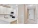 Contemporary kitchen with a view of the entrance, featuring stainless steel appliances and white cabinets at 23445 Collina Way # 10103, Port Charlotte, FL 33980