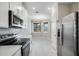 Well-lit kitchen boasts stainless steel appliances and sleek white cabinetry at 23445 Collina Way # 10103, Port Charlotte, FL 33980