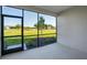Screened lanai with tile flooring overlooks well-manicured lawn at 23445 Collina Way # 10103, Port Charlotte, FL 33980