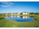 View of the pond and several building exteriors on a sunny day at 23445 Collina Way # 10103, Port Charlotte, FL 33980
