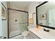 Bathroom features neutral tile, glass enclosed shower, framed mirror and modern vanity at 2401 Ezzell Ct, Sarasota, FL 34237