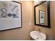 Bathroom features a floating sink, light fixtures, and a framed picture at 2401 Ezzell Ct, Sarasota, FL 34237
