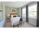 Bedroom featuring warm lighting, carpet flooring, two windows and neutral walls at 2401 Ezzell Ct, Sarasota, FL 34237