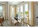 Bright dining area featuring floor to ceiling windows with elegant white curtains and a glass table at 2401 Ezzell Ct, Sarasota, FL 34237