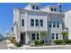 Beautiful townhome featuring neutral paint, decorative windows, and manicured landscaping at 2401 Ezzell Ct, Sarasota, FL 34237