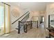 Hallway featuring wood-look tile floors, staircase with black metal spindles, and stylish decor at 2401 Ezzell Ct, Sarasota, FL 34237