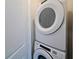 Conveniently stacked washer and dryer unit with white door at 2401 Ezzell Ct, Sarasota, FL 34237