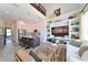 Open concept living area with a large kitchen, bar seating, built-in shelving, and a cozy seating area at 2401 Ezzell Ct, Sarasota, FL 34237