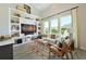 Cozy living room boasts vaulted ceilings, built-in shelving, large windows, and stylish decor at 2401 Ezzell Ct, Sarasota, FL 34237