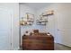 Modern office space featuring a wood desk, open shelving, and stylish decor, perfect for a productive work environment at 2401 Ezzell Ct, Sarasota, FL 34237