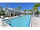 Resort-style community pool with clear blue water and covered seating areas, perfect for relaxation and socializing at 2401 Ezzell Ct, Sarasota, FL 34237