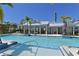 Community pool area with a zero entry area and tropical landscaping, offering a serene and inviting atmosphere at 2401 Ezzell Ct, Sarasota, FL 34237