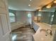 Bathroom featuring a double sink vanity, tub, and wood floors at 2874 56Th Avenue E Cir, Bradenton, FL 34203