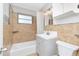 Renovated bathroom with tiled walls, modern vanity, and shower over tub at 2916 Cambridge Dr, Sarasota, FL 34232