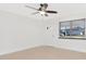 Neutral-toned living room with a new ceiling fan and window overlooking the neighborhood at 2916 Cambridge Dr, Sarasota, FL 34232