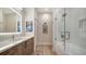 Stylish bathroom featuring a bath tub, a sleek vanity with a mirror, and a glass-enclosed shower at 3016 Highlands Bridge Rd, Sarasota, FL 34235