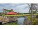 Picturesque view of the golf course with a waterfront gazebo and well-manicured greens at 3016 Highlands Bridge Rd, Sarasota, FL 34235